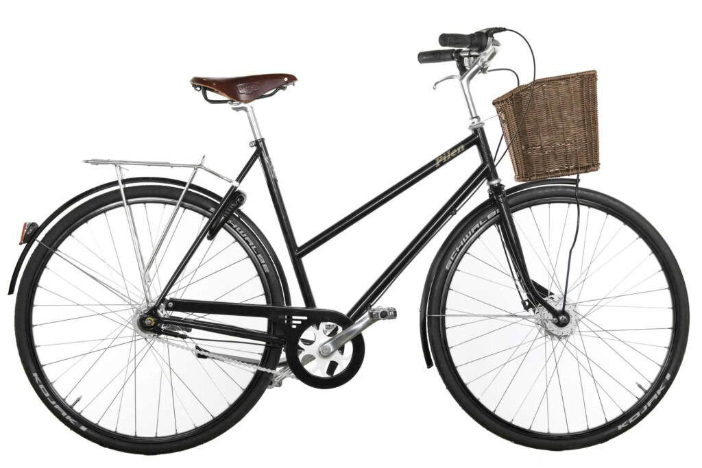 Pilen GT dam Svart RAL 9005. Svarta fälgar. Täckande kedjeskydd. Extrautrustad: helfärgade cykel, täckande kedjeskydd i ramfärgen, sadel Brooks B17 brun i äkta läder, brun korg (framlyset monteras på höger gaffelben (visas inte på bilden)) och däck Schwalbe Kojak.